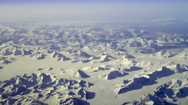 Aerial view of arctic mountains near Kluane National Park, Yukon Territory, Canada. Steady, slow motion shot.