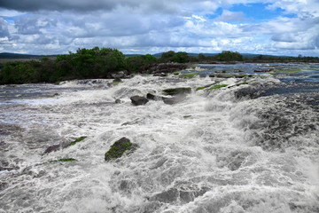 Fototapeta na wymiar Powerful water stream at the edge of waterfall 