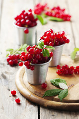 Fresh red currant on the wooden table