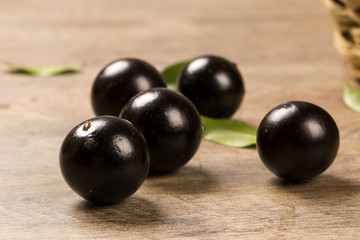 Berry Jaboticaba in bowl on wooden table