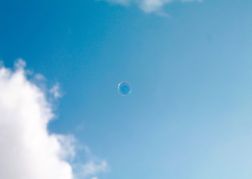A single bubble against a blue sky