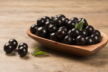 Berry Jaboticaba in bowl on wooden table