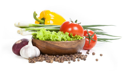 Vegetable isolated on a white background. Vegetables and spices isolated on white background. Vegetables on the plate on a white background. Harvest vegetables. Vegetables in a wooden plate.