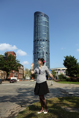 Dziewczyna w kapeluszu na tle Sky Tower Wrocław.