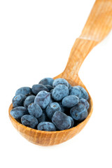 Honeysuckle berries in a wooden spoon