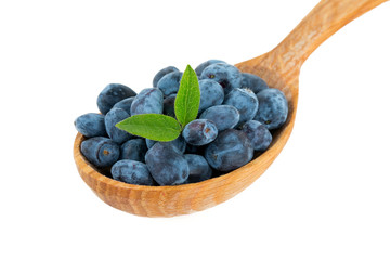 Honeysuckle berries in a wooden spoon