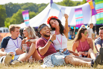Friends taking selfie at a music festival
