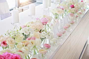 Wedding table decoration.  Ranunculus, roses, candels