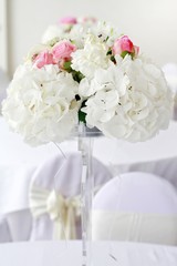 Flower arrangement  for wedding table. Hydrangea and roses.
