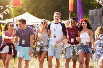 Group of friends walking through a music festival site