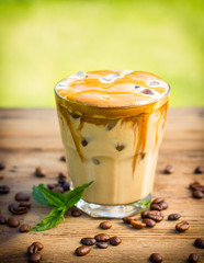 Ice coffee in a glass on the wooden table 