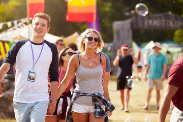 Couple walking through music festival