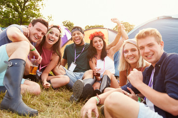 Friends having fun on the campsite at a music festival