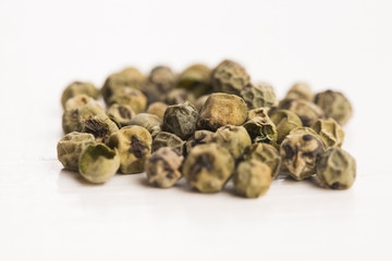 Green Peppercorns on wooden background