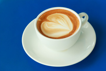 cup of hot coffee on the blue table