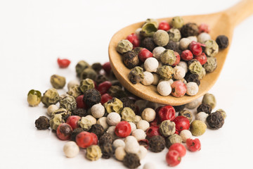 Mixed green, red, white and black peppercorns