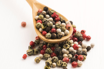 Mixed green, red, white and black peppercorns