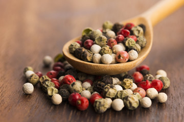 Mixed green, red, white and black peppercorns