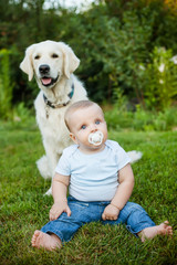 Little boy with a golden retriever outdoor