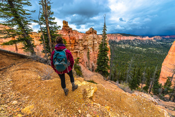 Woman Backpacker hiking down the Ponderosa Canyon Bryce National