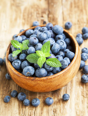 Blueberries in a Wooden Bowl with Mint Leaf