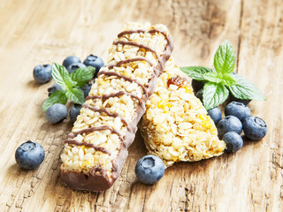Chocolate Muesli Bar with Blueberries on Wooden Background