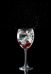 Three cherries in a glass drops splashing