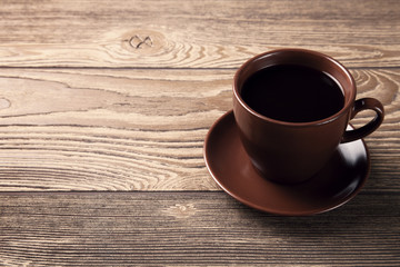 Cup of fresh espresso on wooden table