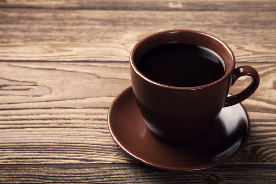 Cup of fresh espresso on wooden table