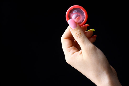 open red condom  in the hand