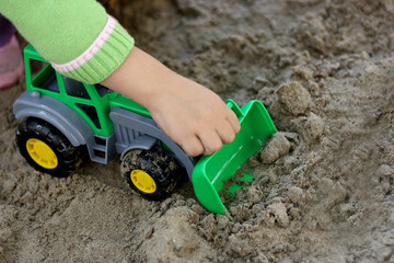 Child with green excavator