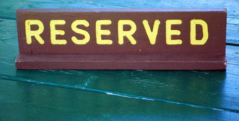 Reserved wooden sign on a campground site table.