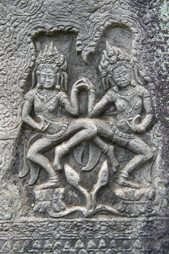 Sculptural relief in stone carving of traditional female goddesses known as apsara dancers at Angkor Wat, Cambodia