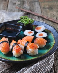 homemade sushi with wild salmon, shrimp, cucumber and seaweed. selective focus