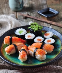 homemade sushi with wild salmon, shrimp, cucumber and seaweed. selective focus