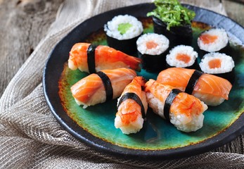 homemade sushi with wild salmon, shrimp, cucumber and seaweed. selective focus