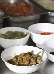 Food condiments in round dishes.