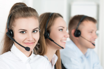 Portrait of call center worker accompanied by her team