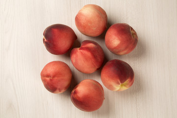 Some peaches in a basket over a white background