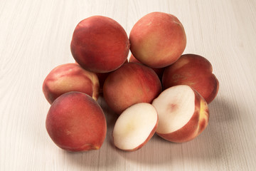 Some peaches in a basket over a white background