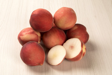Some peaches in a basket over a white background
