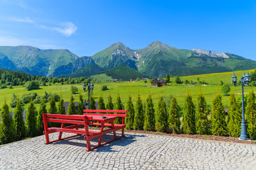 Naklejka premium Picnic table on Zdiar village with view of Tatry Bielskie Mountains in summer, Slovakia