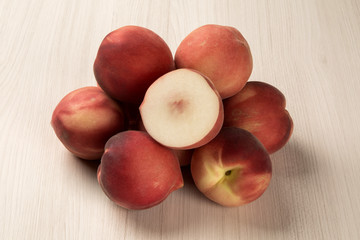 Some peaches in a basket over a white background