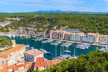 View of Bonifacio port with colorful houses and boats, Corsica island, France.