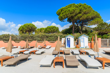 Sunchairs on famous white sand Palombaggia beach, Corsica island, France