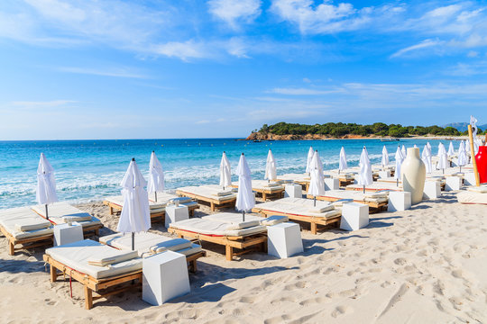 Sunchairs on famous white sand Palombaggia beach, Corsica island, France