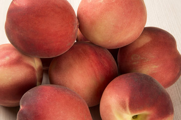 Some peaches in a basket over a white background