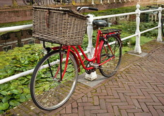 Red Bicycle Beside a Canal in Netherlands