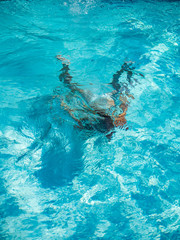 girl diving in the swimming pool