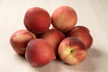 Fototapeta na wymiar Some peaches in a basket over a white background